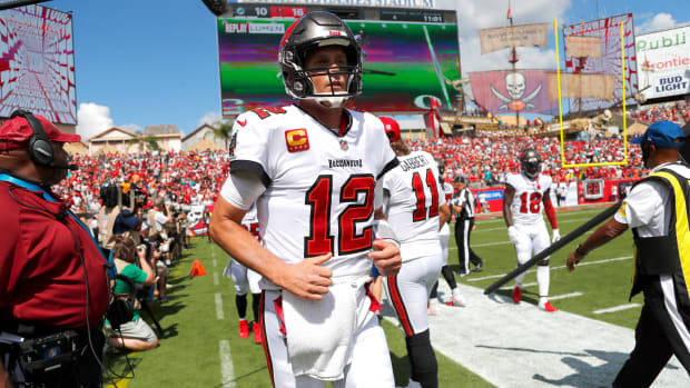 Oct 10, 2021; Tampa, Florida, USA; Tampa Bay Buccaneers quarterback Tom Brady (12) runs to the sidelines as they scored a touchdown against the Miami Dolphins during the second quarter at Raymond James Stadium. Mandatory Credit: Kim Klement-USA TODAY Sports